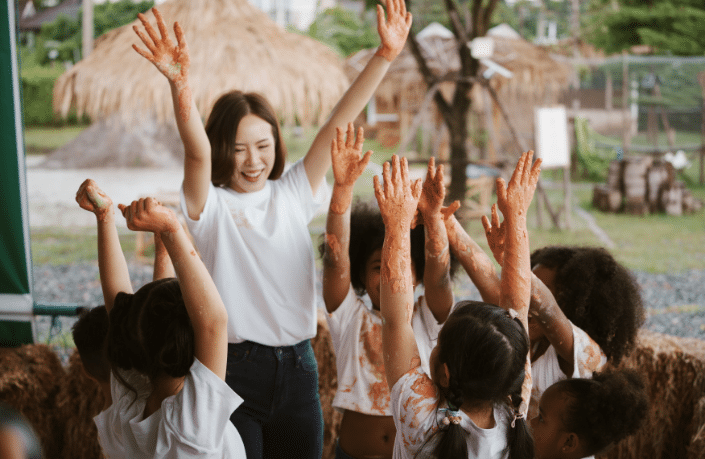 group-of-children-playing-colourful-water-colours-2023-11-27-05-24-22-utc